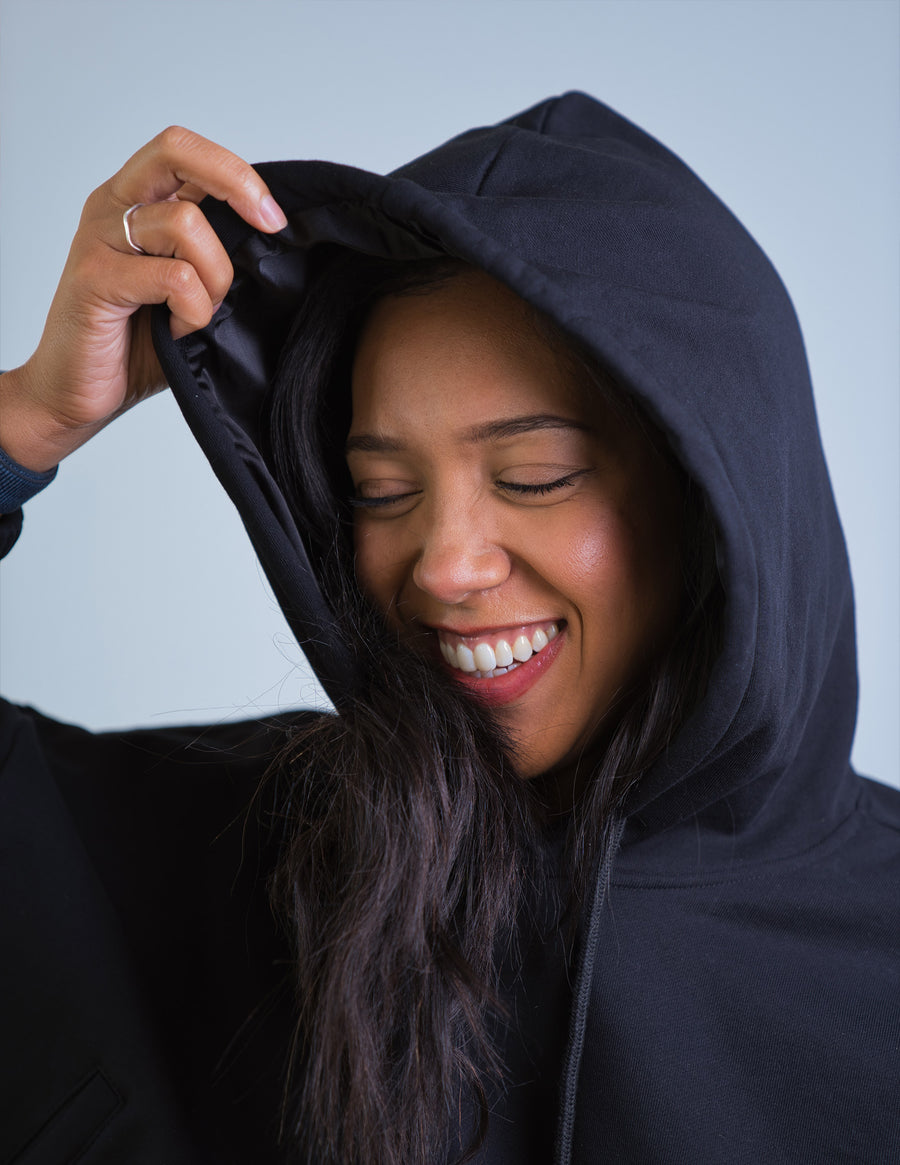 Model wearing Thick Athletics Crop Hoodie closeup of satin hood