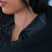 Model wearing Thick Athletics Crop Hoodie closeup of satin hood